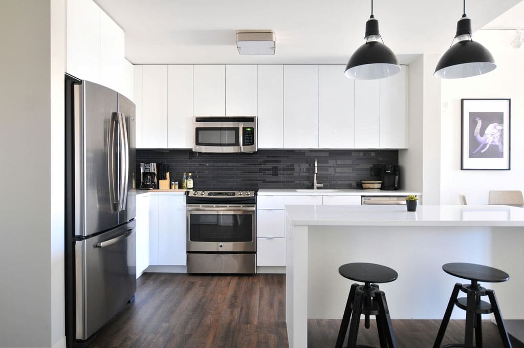 Bright and clean kitchen design featuring white cabinetry and countertops