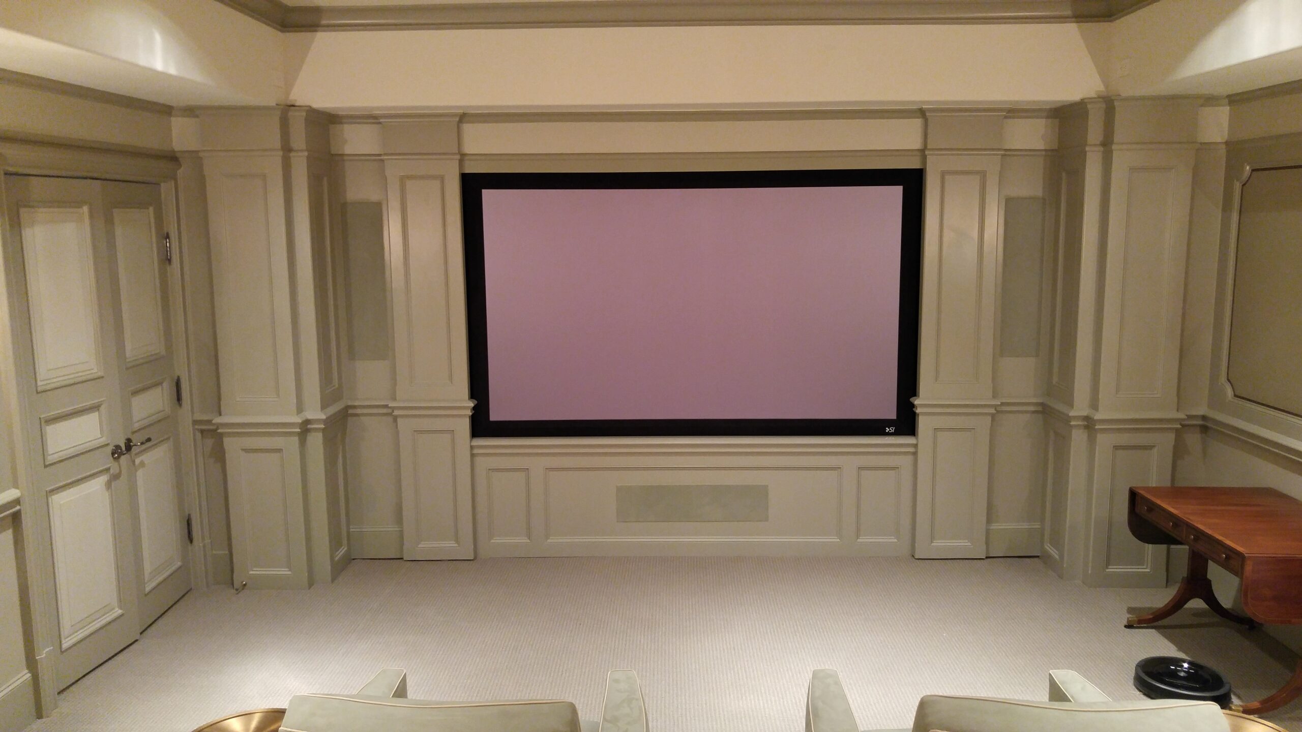 AVR theater room with cream walls and a large screen at the center