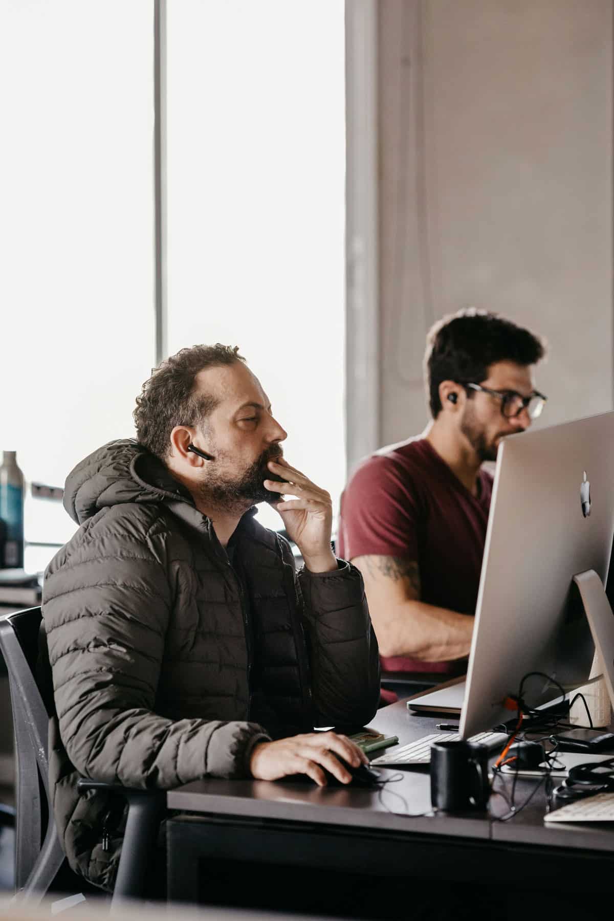Man deep in thought while facing a computer screen
