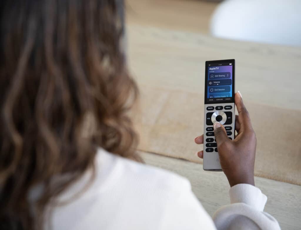 Person using a touchscreen universal remote.
