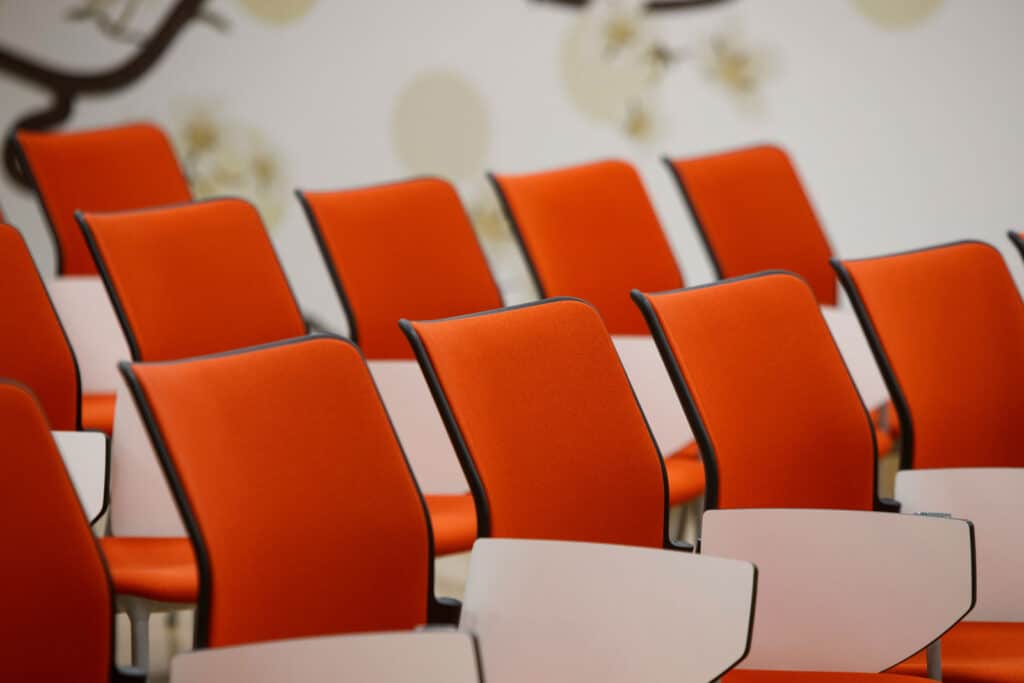 Pro-TechT-installed orange lecture hall chairs.