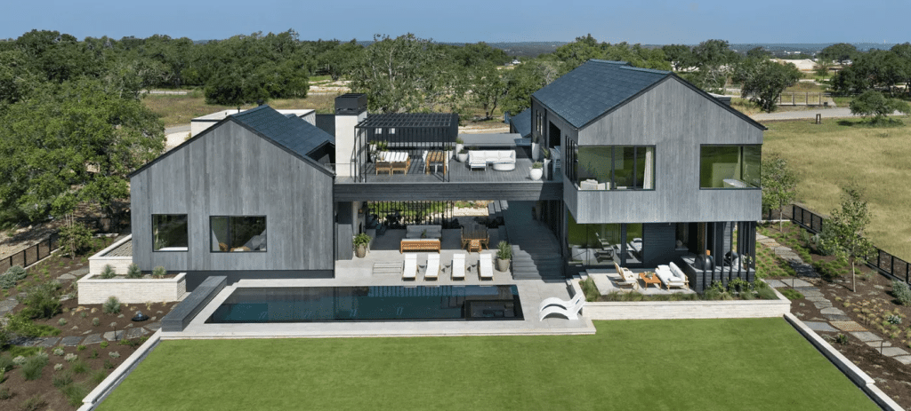 Modern two-story home with pool and large lawn.