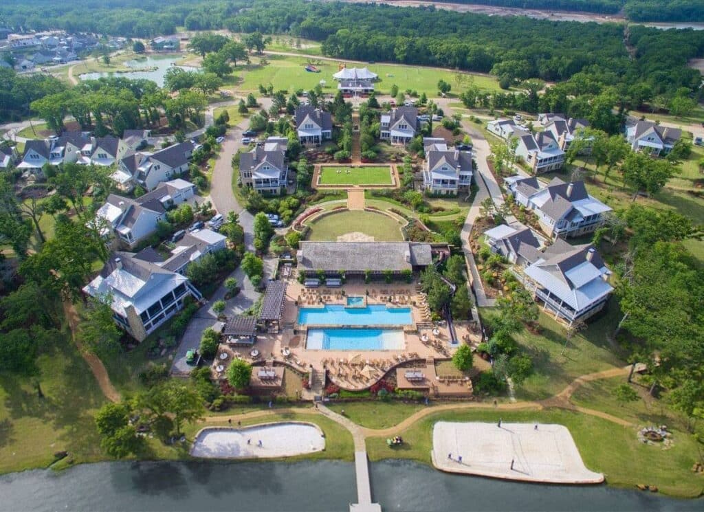 Aerial view of resort with villas, pools, and lakefront.
