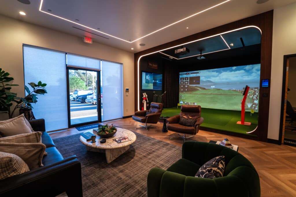 Pro-TechT custom golf simulator room featuring integrated TrackMan system, premium finishes, and lounge-style seating