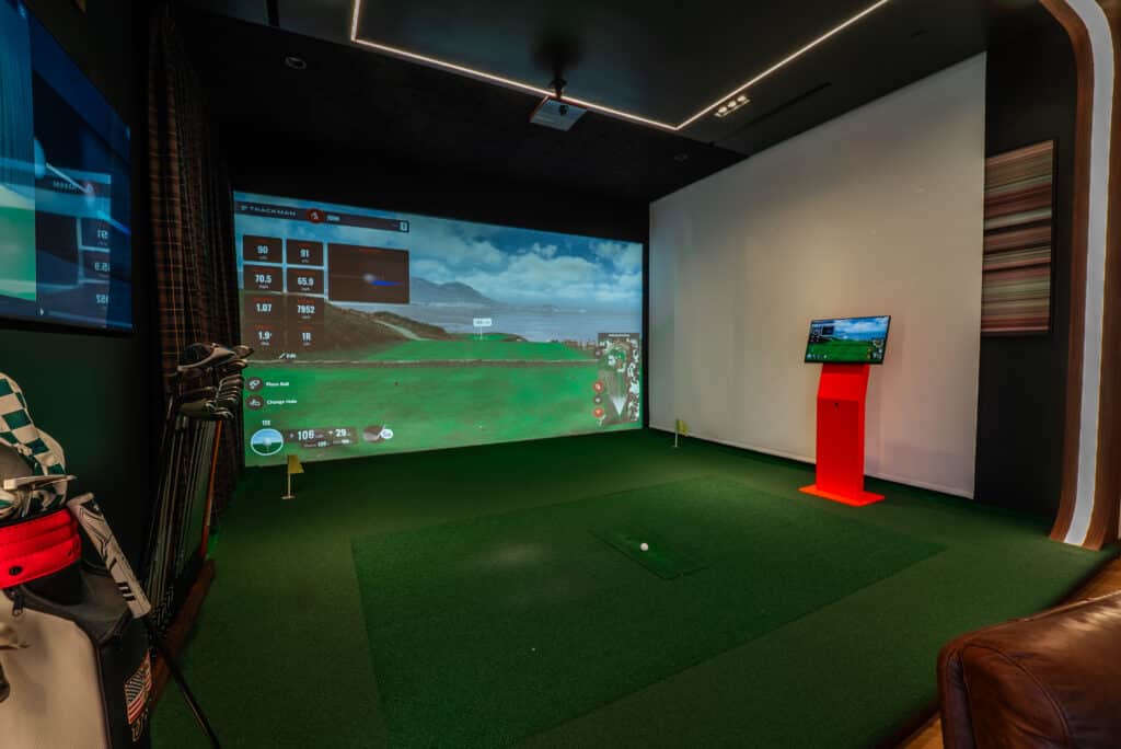 Custom golf simulator room designed by Pro-TechT—precision TrackMan setup, premium finishes, and integrated smart-home controls.
