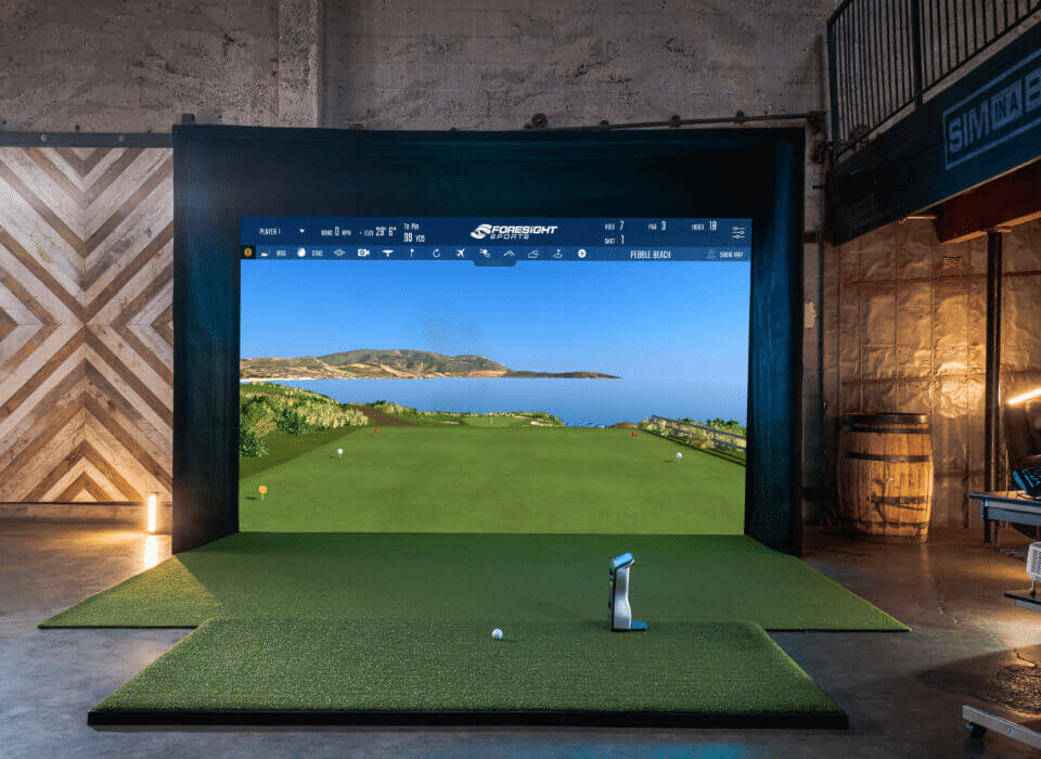 Foresight Sports golf simulator setup with GC launch monitor in a Pro-TechT custom room, displaying lifelike Pebble Beach course visuals